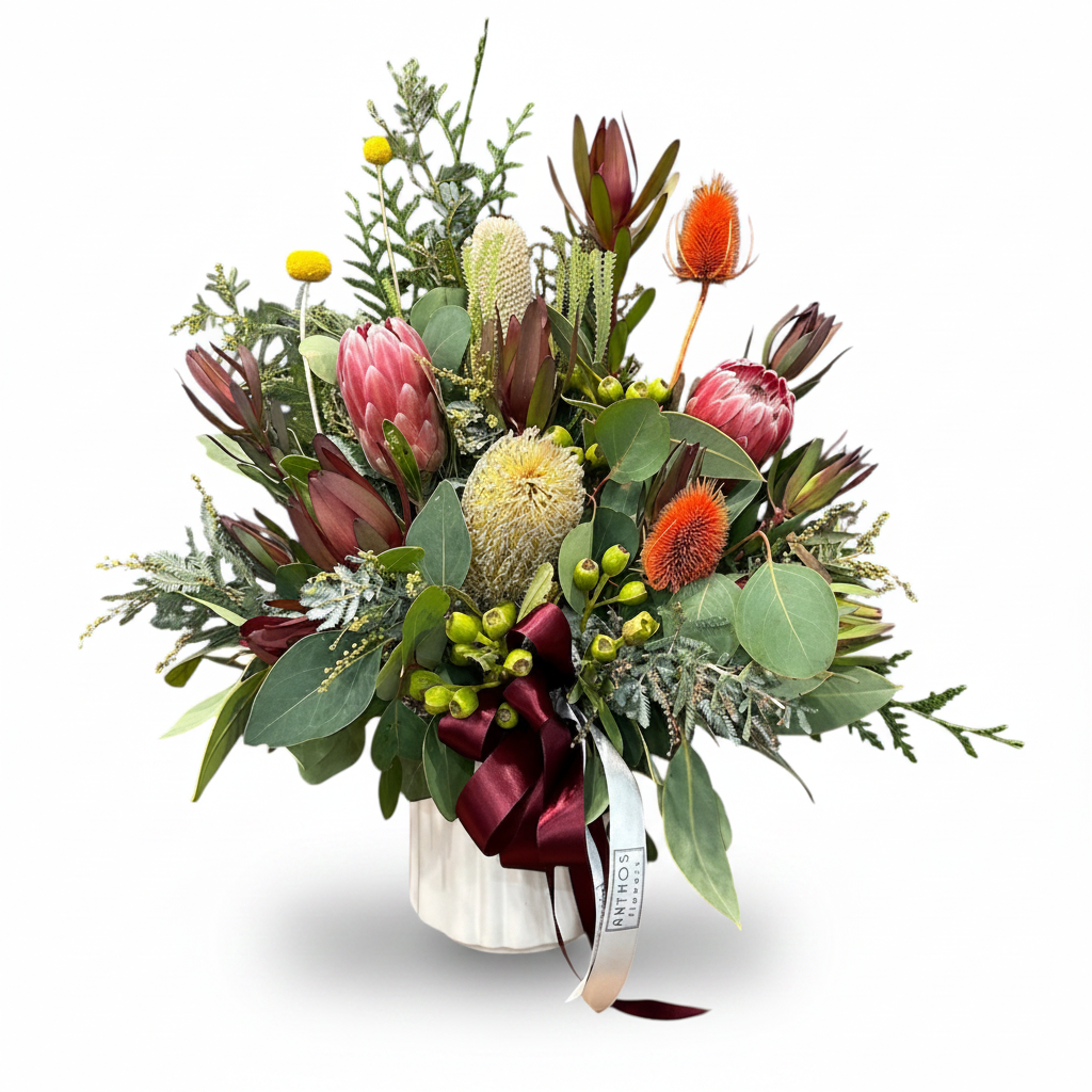 Native Flower Arrangement in Ceramic Vase on a pure white background